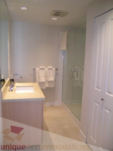 Furnished bathroom with white countertops and a glass shower enclosure. - 208 - 1833 Crowe St., Vancouver West Side