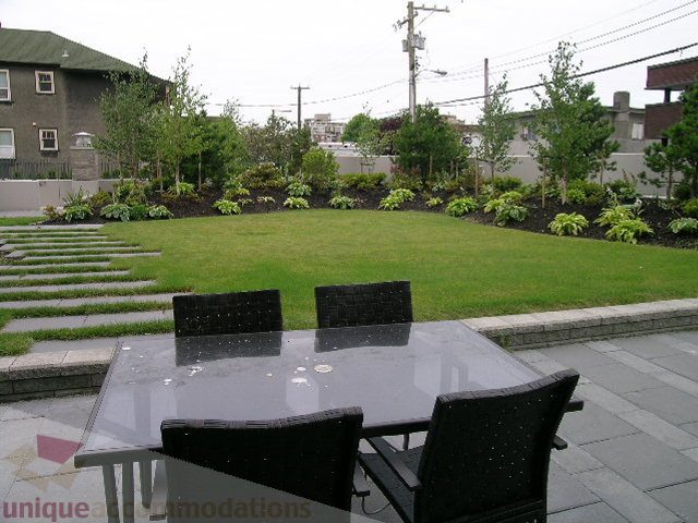 Furnished patio with modern furniture, greenery, and paved walkways. - 102 - 1333 West 11th Ave., Vancouver West Side
