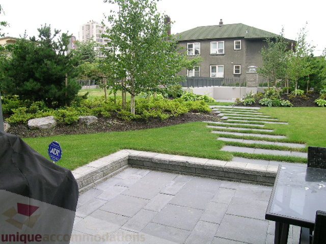 Furnished patio with stone steps, greenery, and modern landscaping. - 102 - 1333 West 11th Ave., Vancouver West Side