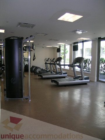 Spacious fitness room with cardio machines and large windows. - 1209 - 1055 Richards Street, Vancouver Downtown