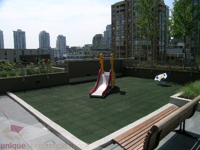 Bright rooftop patio with green turf, playground equipment, and city views. - 1209 - 1055 Richards Street, Vancouver Downtown
