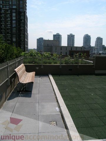 Spacious rooftop patio with city view and green turf. - 1209 - 1055 Richards Street, Vancouver Downtown