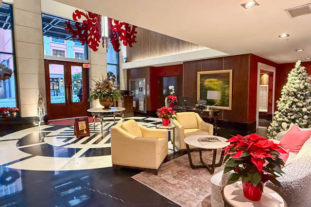 Spacious living room with festive decor, modern furniture, and a Christmas tree. - 1802 - 788 Richards, Vancouver Downtown