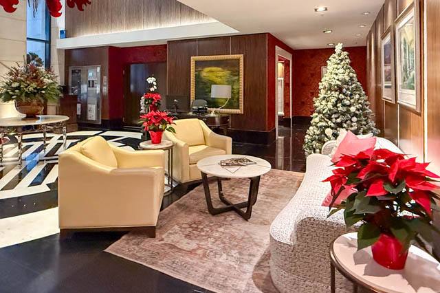 Spacious living room with a festive Christmas tree, elegant furniture, and a modern decor. - 1802 - 788 Richards, Vancouver Downtown