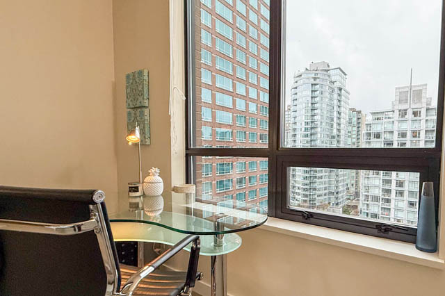 Modern dining area with glass table and chairs, featuring a stunning city view. - 1802 - 788 Richards, Vancouver Downtown