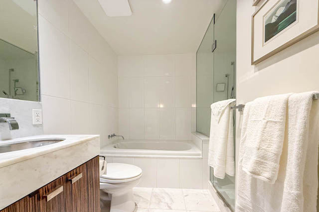 Spacious bathroom with marble countertops and a glass shower enclosure. - 1802 - 788 Richards, Vancouver Downtown