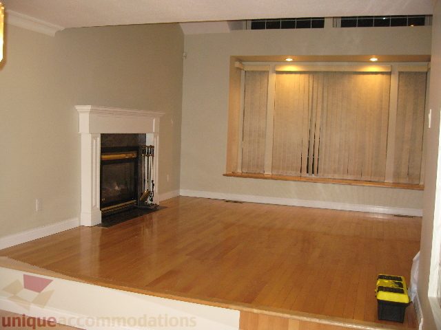 Living room with hardwood floors and a fireplace. - 2737 Mahon Ave., North Vancouver