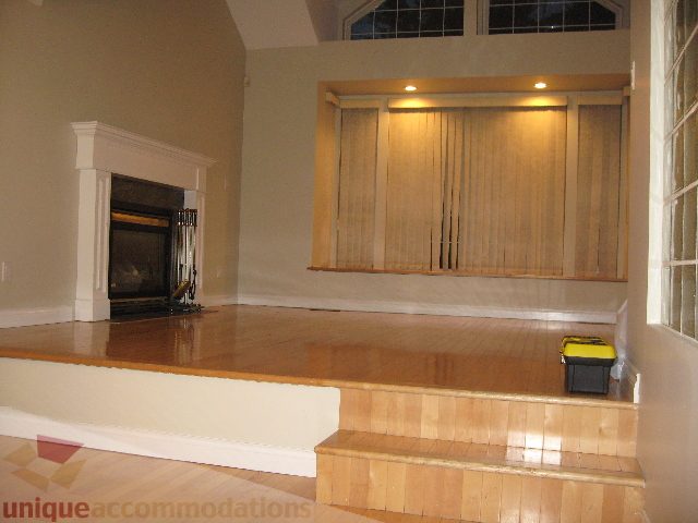 Living room with hardwood floors and a fireplace. - 2737 Mahon Ave., North Vancouver