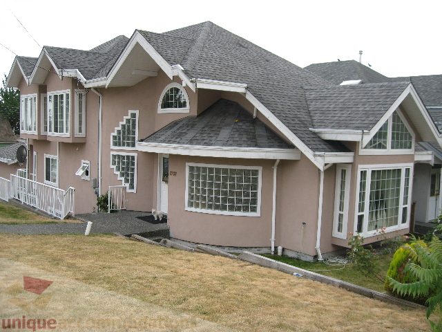 Furnished 4-bedroom house with unique architectural design, large windows, and a sloped roof. - 2737 Mahon Ave., North Vancouver