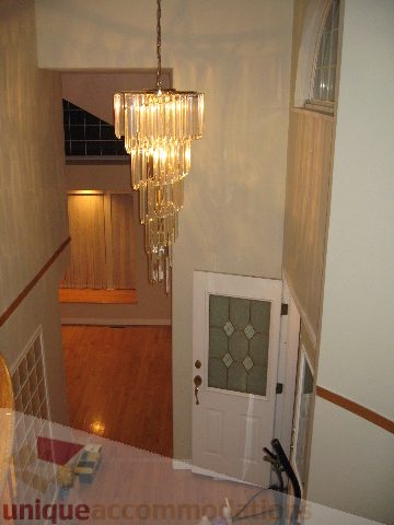 Entryway with chandelier and hardwood floors. - 2737 Mahon Ave., North Vancouver