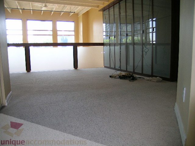 Spacious living room with large windows and carpeted floor. - 408 - 1066 Hamilton Street, Vancouver Downtown