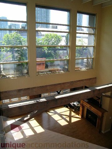 Bright living room with large windows, hardwood floors, and city view. - 408 - 1066 Hamilton Street, Vancouver Downtown