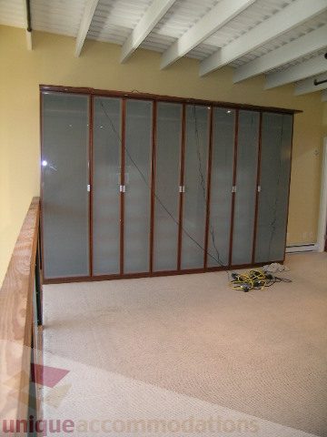 Spacious living room with large glass sliding doors and carpeted floor. - 408 - 1066 Hamilton Street, Vancouver Downtown