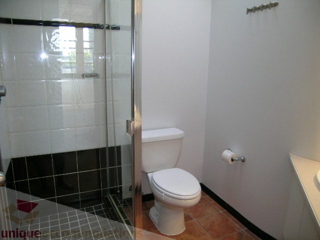 Small, clean bathroom with white toilet, glass shower, and tiled floor. - 408 - 1066 Hamilton Street, Vancouver Downtown
