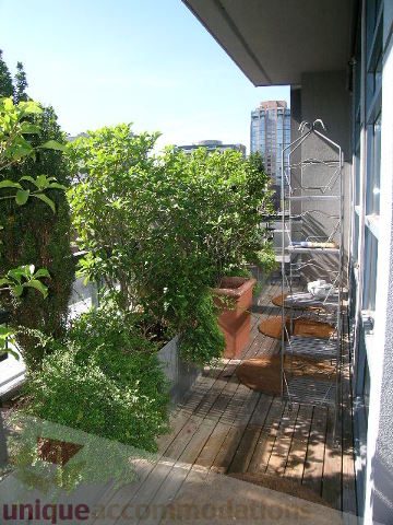 Furnished balcony with lush greenery and city view. - 408 - 1066 Hamilton Street, Vancouver Downtown