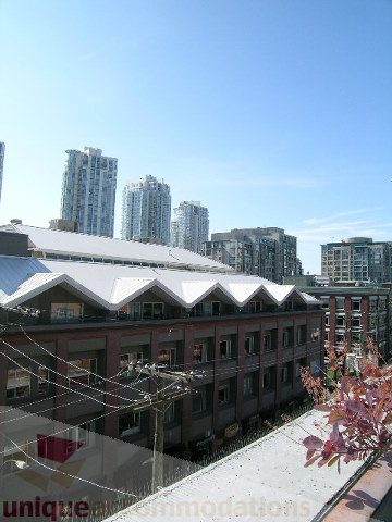 Bright living room with city view and modern furnishings. - 408 - 1066 Hamilton Street, Vancouver Downtown