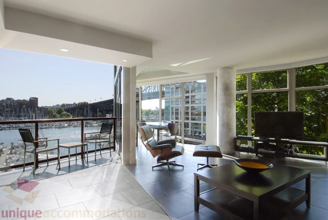 Furnished living room with city view and modern furniture. - 310 - 990 Beach, Vancouver Downtown