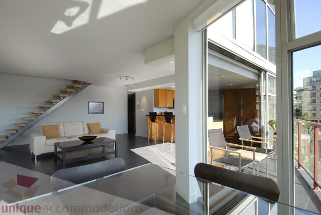 Bright living room with modern furnishings and city view. - 310 - 990 Beach, Vancouver Downtown