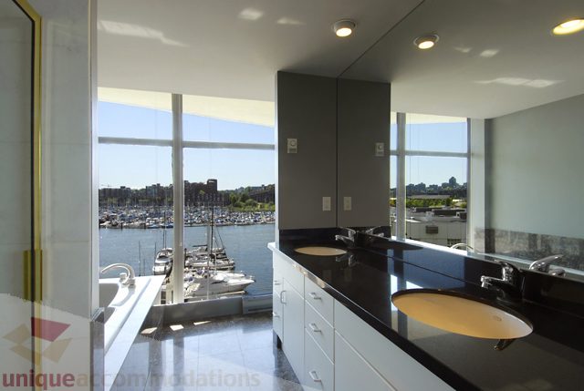 Bright kitchen with black countertops and city view. - 310 - 990 Beach, Vancouver Downtown