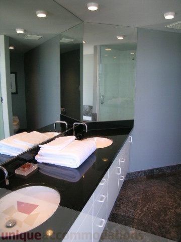 Furnished bathroom with black countertops and white towels, modern design. - 310 - 990 Beach, Vancouver Downtown