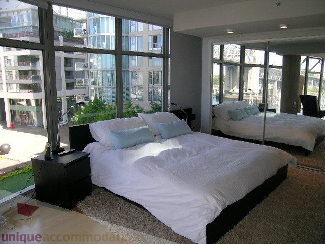Furnished 2-bedroom condo with large windows offering city views. - 310 - 990 Beach, Vancouver Downtown