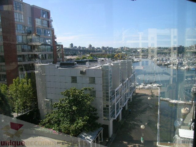 Bright living room with city view and marina, modern furnishings. - 310 - 990 Beach, Vancouver Downtown