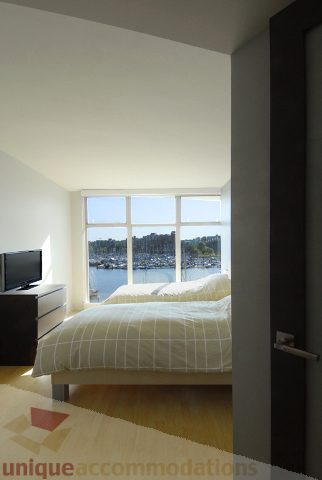 Bright bedroom with city view and wooden floors. - 310 - 990 Beach, Vancouver Downtown