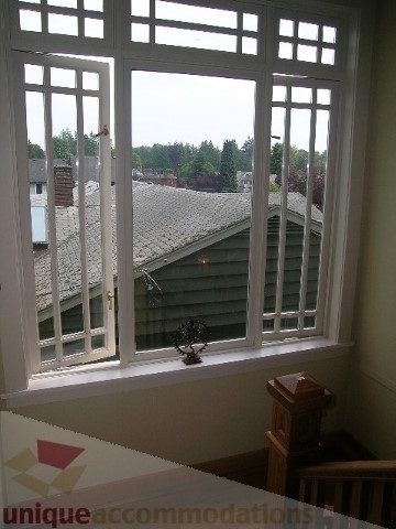Bright sunroom with city view and decorative lamp. - 4035 West 27th Avenue, Vancouver West Side