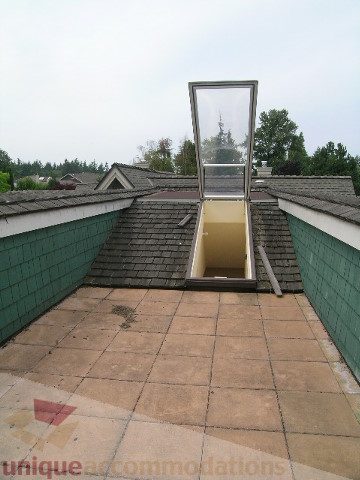 Bright rooftop deck with skylight and green roof tiles. - 4035 West 27th Avenue, Vancouver West Side