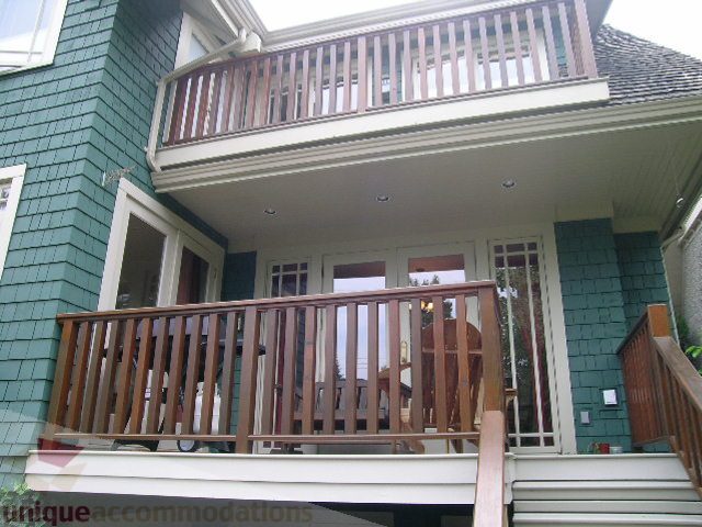 Furnished 3-bedroom + den house with wooden deck and green siding. - 4035 West 27th Avenue, Vancouver West Side