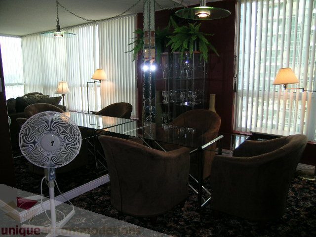Furnished living room with mirrored furniture, city view, and modern decor. - 1403 - 555 Jervis Street, Vancouver Downtown