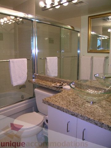 Bathroom with granite countertops and a glass shower. - 1403 - 555 Jervis Street, Vancouver Downtown