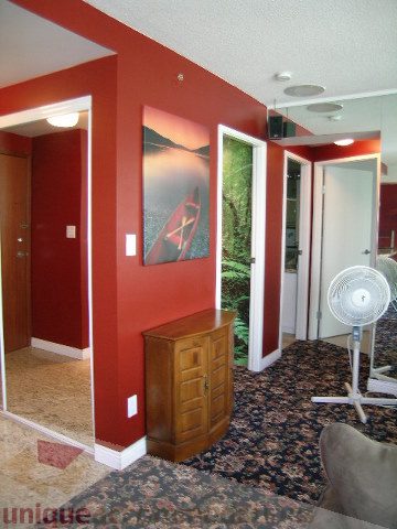 Bright living room with red walls, hardwood floors, and a city view. - 1403 - 555 Jervis Street, Vancouver Downtown