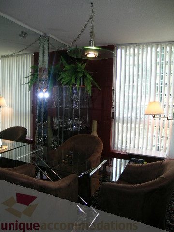 Furnished living room with modern chandelier and large windows, showcasing a cozy ambiance. - 1403 - 555 Jervis Street, Vancouver Downtown