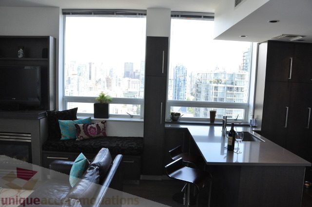 Bright living room with city view and modern furnishings. - 2702 - 638 Beach Crescent, Vancouver Downtown