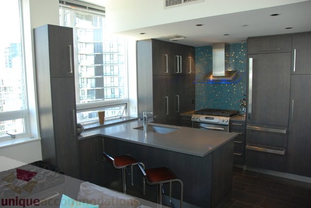 Bright kitchen with modern cabinets, stainless steel appliances, and a city view. - 2702 - 638 Beach Crescent, Vancouver Downtown