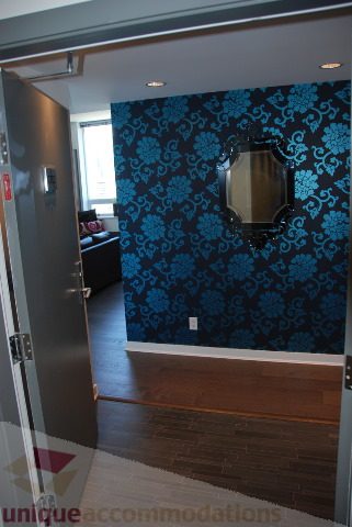 Foyer with dark blue floral wallpaper and a sleek mirror. - 2702 - 638 Beach Crescent, Vancouver Downtown