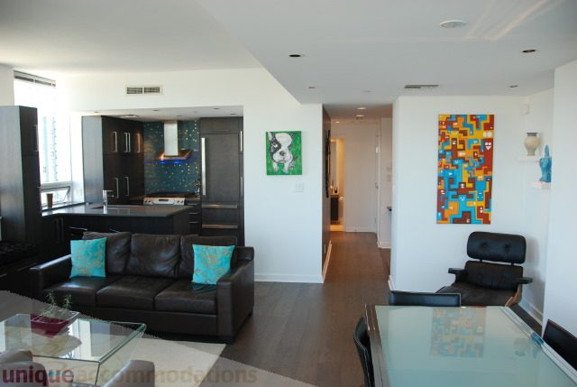 Bright living room with modern furniture, hardwood floors, and city view. - 2702 - 638 Beach Crescent, Vancouver Downtown