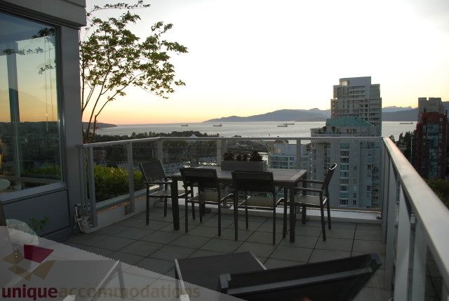 Furnished rooftop patio with city view and ocean in the distance. - 2702 - 638 Beach Crescent, Vancouver Downtown