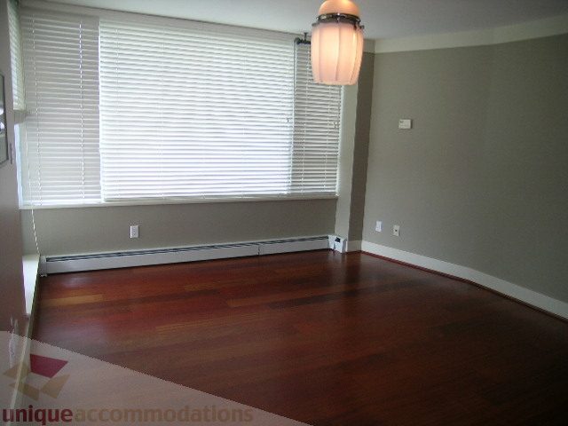 Spacious living room with hardwood floors and large windows. - 603 - 1383 Marinaside Crescent, Vancouver Downtown