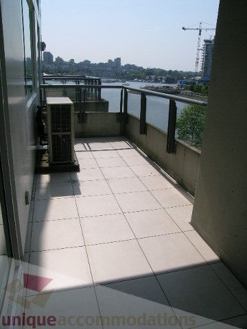 Furnished balcony with city view and water access. - 603 - 1383 Marinaside Crescent, Vancouver Downtown