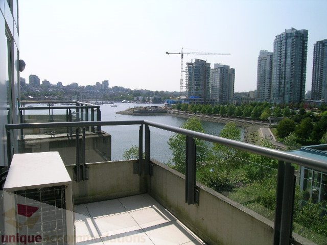 Bright balcony with city view and modern furnishings. - 603 - 1383 Marinaside Crescent, Vancouver Downtown