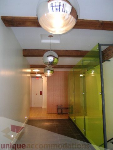 Furnished living room with modern pendant lights and glass walls. - 902 - 528 Beatty Street, Vancouver Downtown