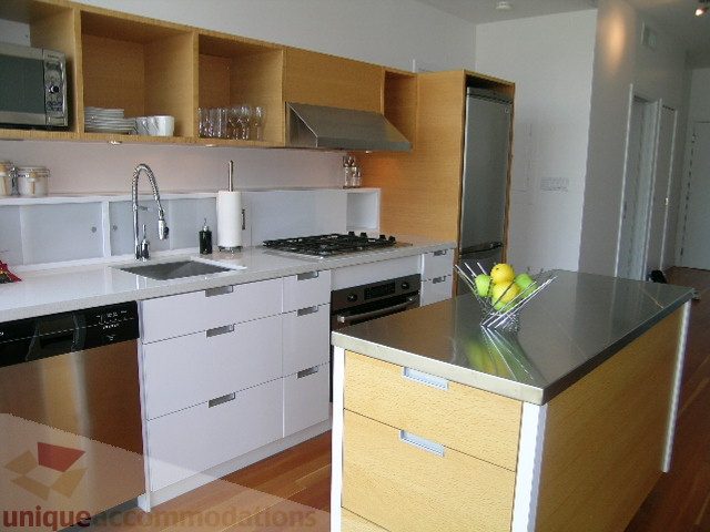 Bright kitchen with white countertops, stainless steel appliances, and wooden cabinets. - 902 - 528 Beatty Street, Vancouver Downtown