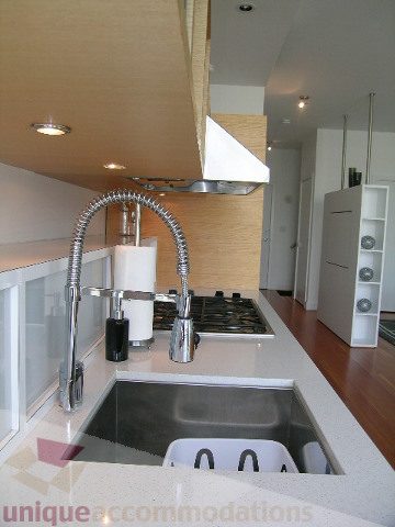 Bright kitchen with modern stainless steel sink, white countertops, and hardwood floors. - 902 - 528 Beatty Street, Vancouver Downtown