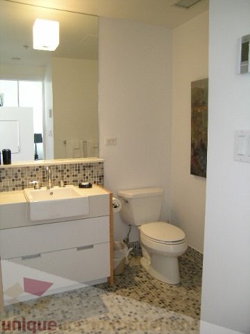 Bright bathroom with white vanity and mosaic tile floor. - 902 - 528 Beatty Street, Vancouver Downtown