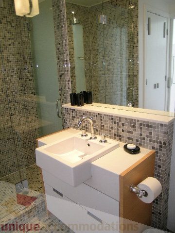 Modern bathroom with mosaic tile backsplash and dual sinks. - 902 - 528 Beatty Street, Vancouver Downtown