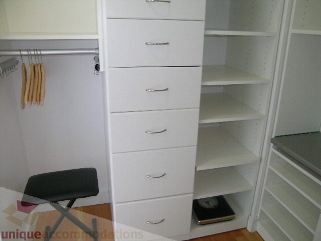 Furnished closet with white drawers and open shelving, neat and tidy. - 902 - 528 Beatty Street, Vancouver Downtown