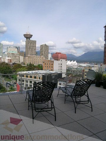 Furnished balcony with city view, modern chairs, and patio furniture. - 902 - 528 Beatty Street, Vancouver Downtown