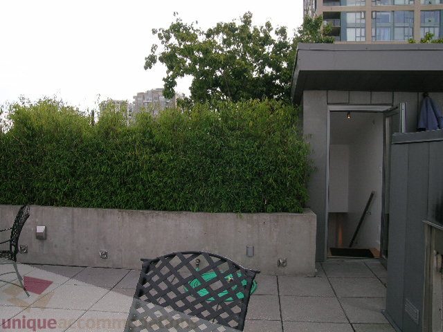 Furnished patio with greenery and modern building view. - 902 - 528 Beatty Street, Vancouver Downtown